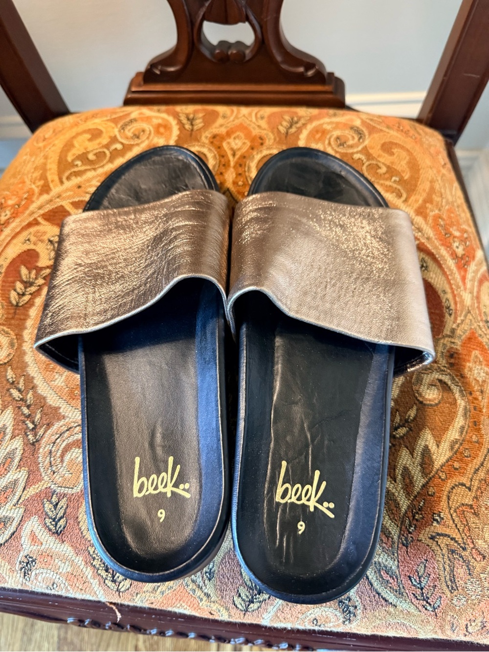 Beek leather slides. Gold Metallic/black.Memory foam footbed.Size 9 Gently used